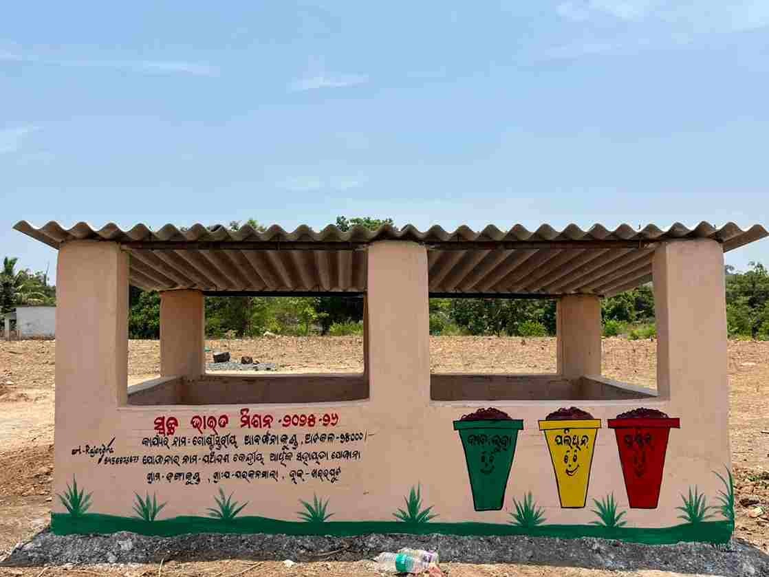 A solid-waste collection and segregation structure painted with three coloured waste bins