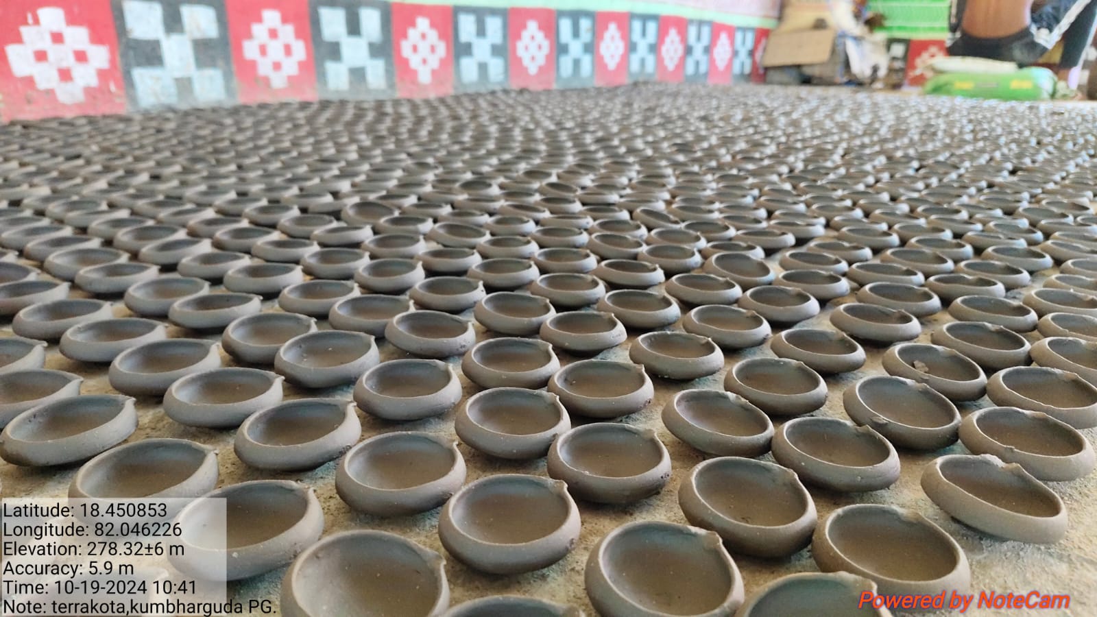 Hundreds of newly shaped clay diyas arranged inside the pottery workshop