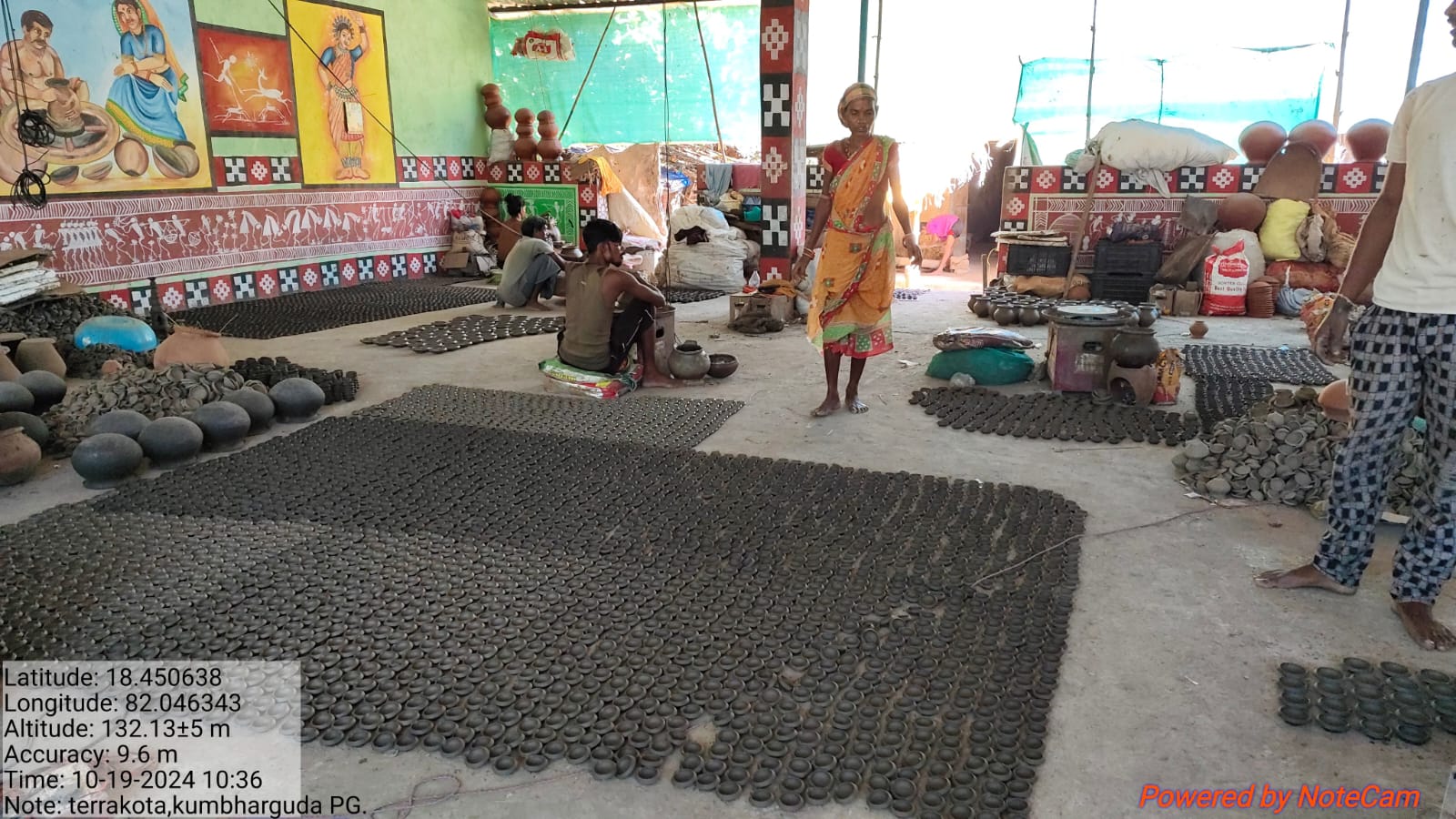 Members working among large rows of clay diyas inside the Kumbharguda workshop