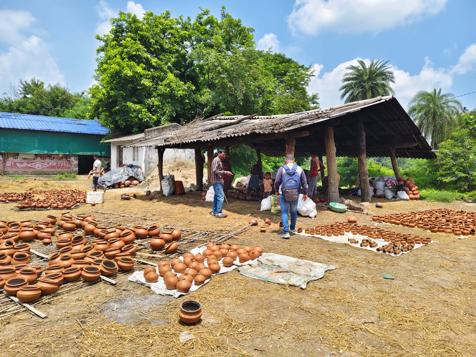 Rows of terracotta products drying across the Kumbharguda pottery yard